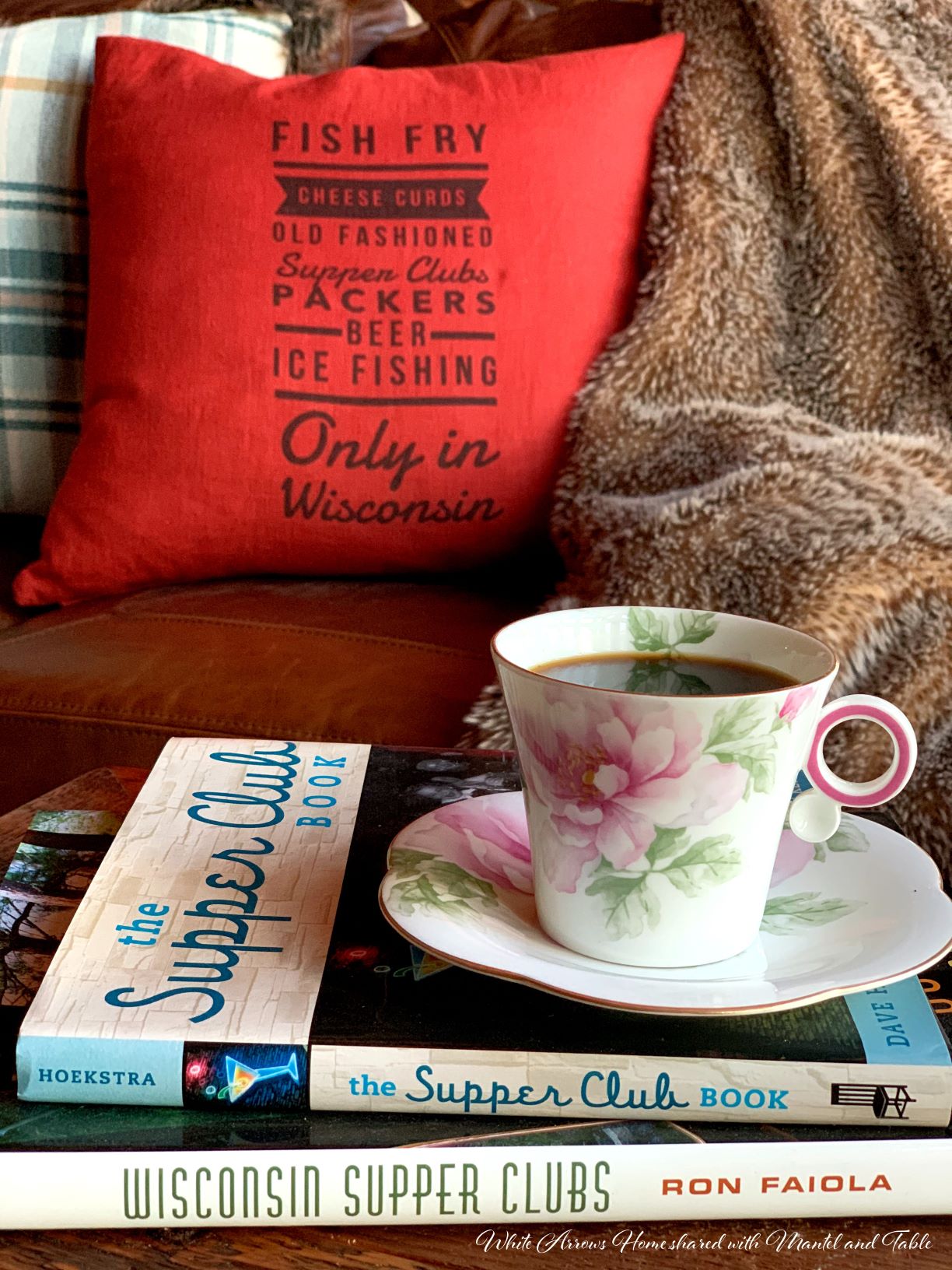 Teacup resting on Supper Club books