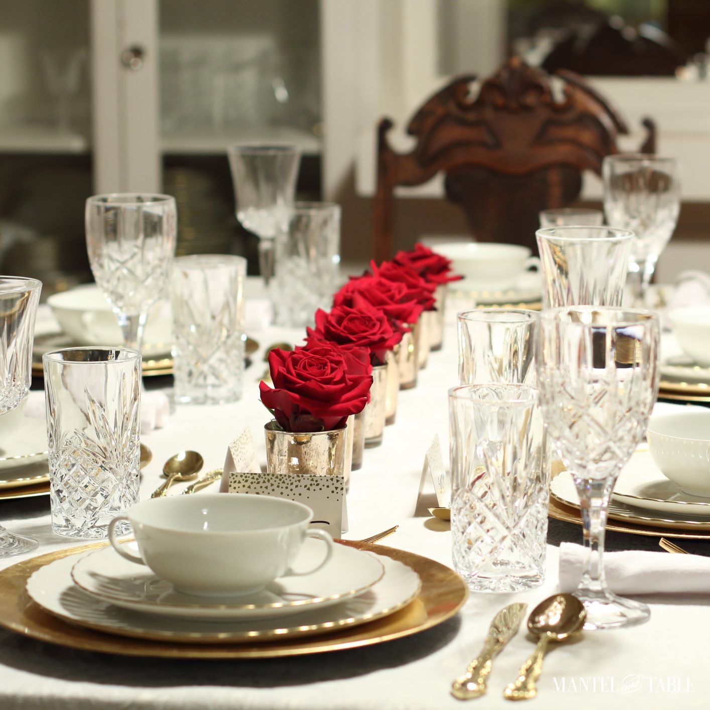 Top 10 Favorites - #1. White and gold formal table setting with crystal glasses and straight row of red roses down the middle of the table