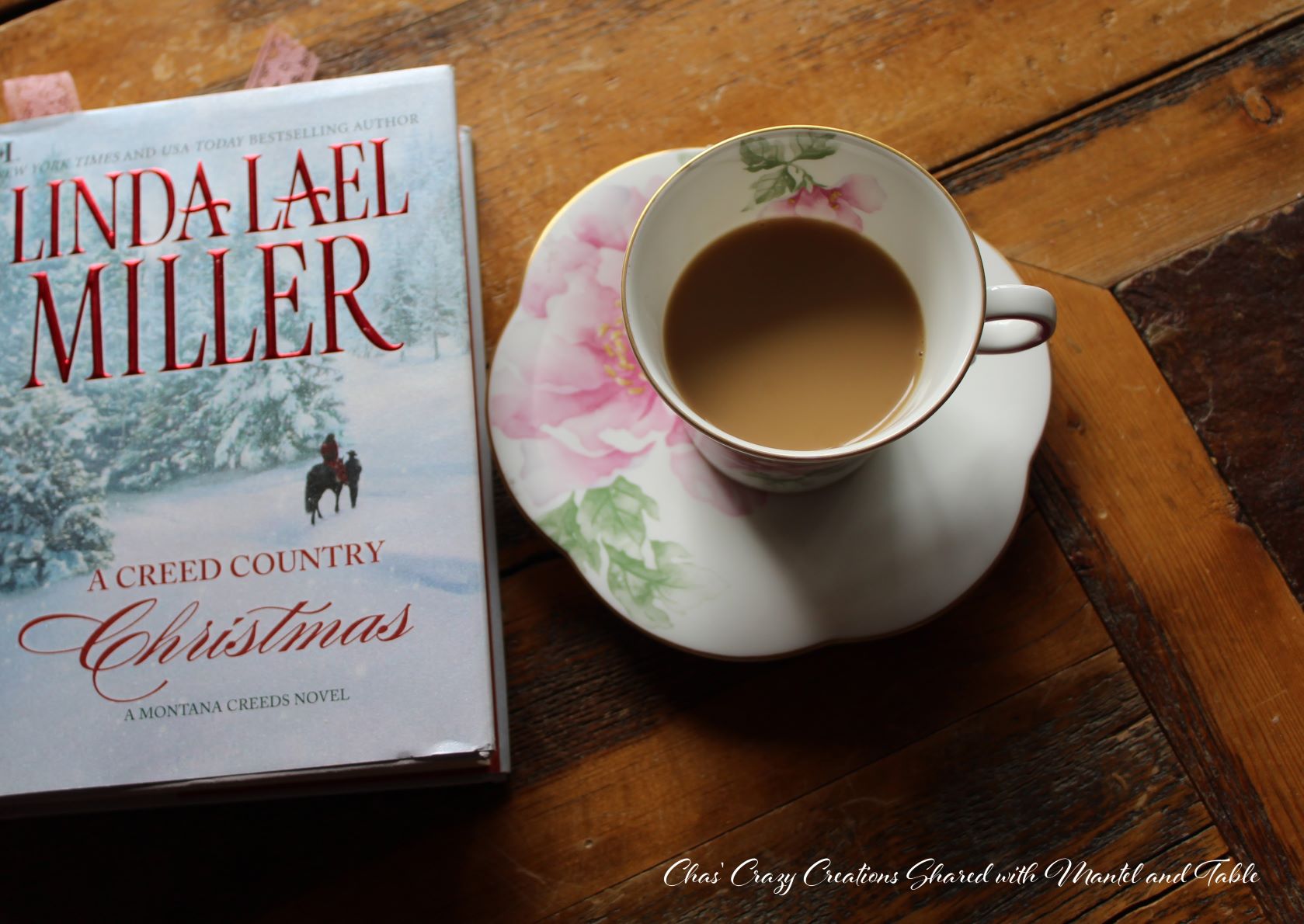 Teacup and Christmas novel on wood table