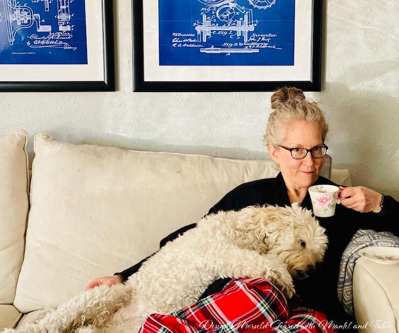 Andrea and her puppy drinking tea on a white couch