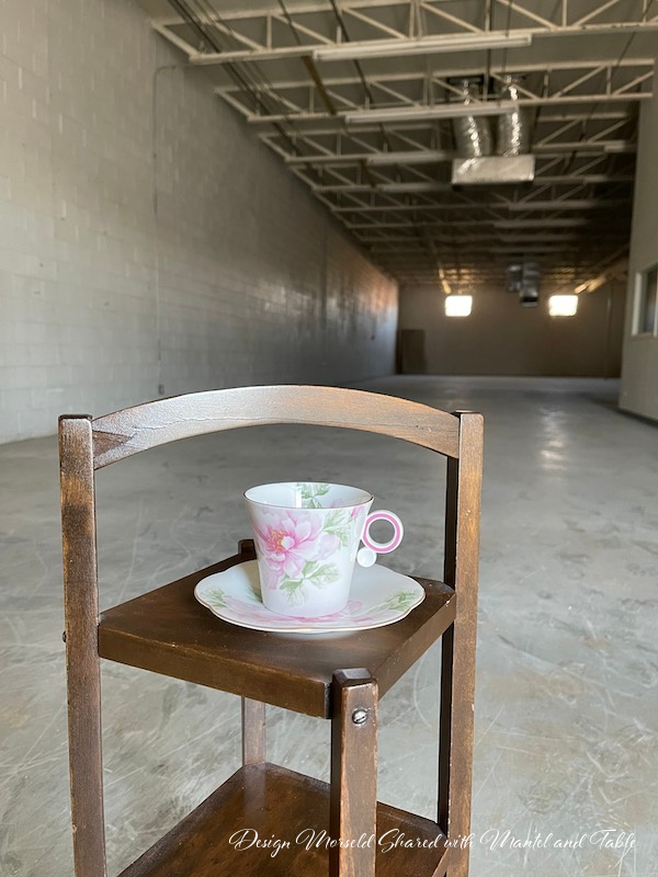 Teacup on wooden stand in empty warehouse