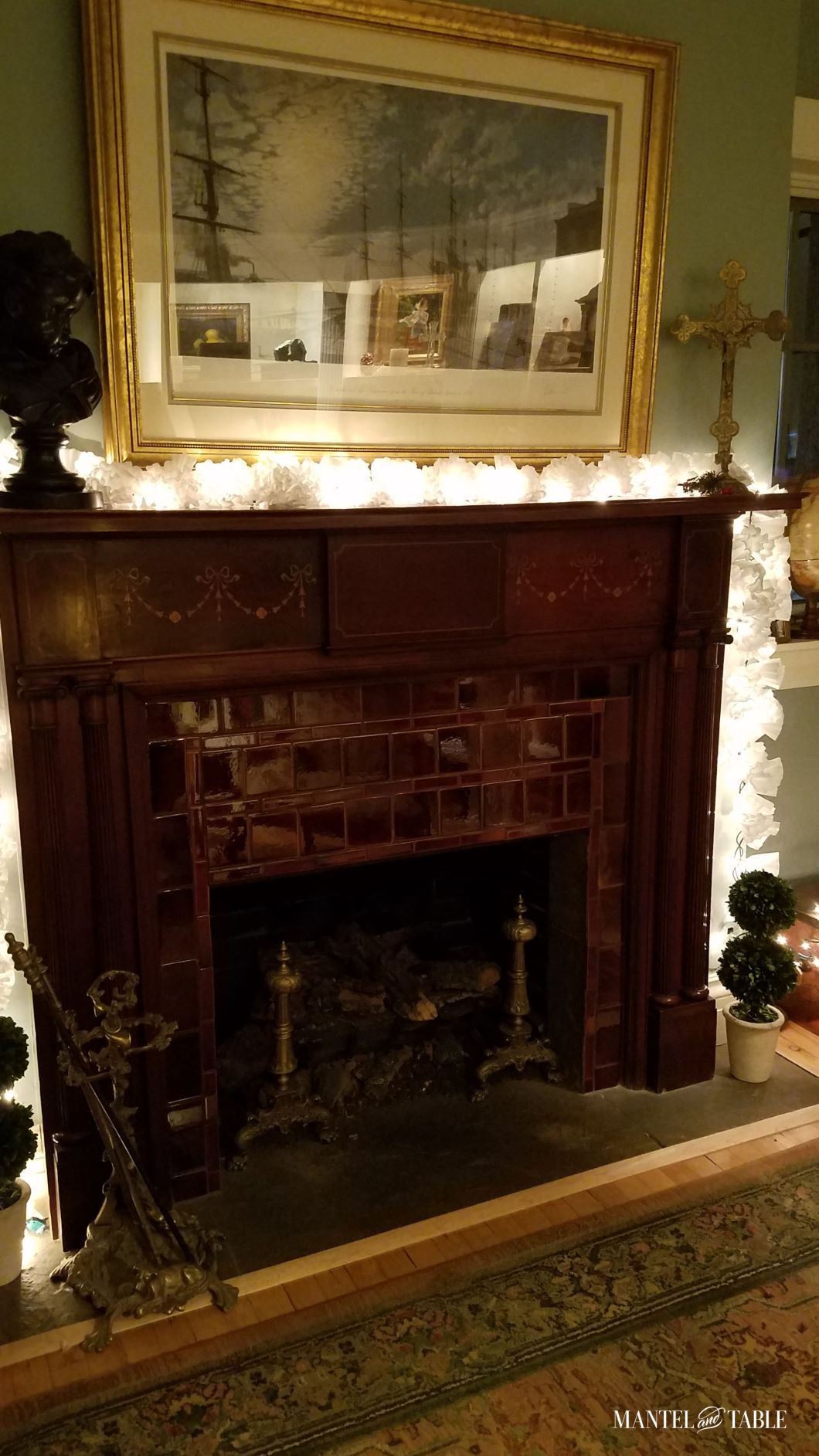 Deep brown elegant mantel with lighted white garland