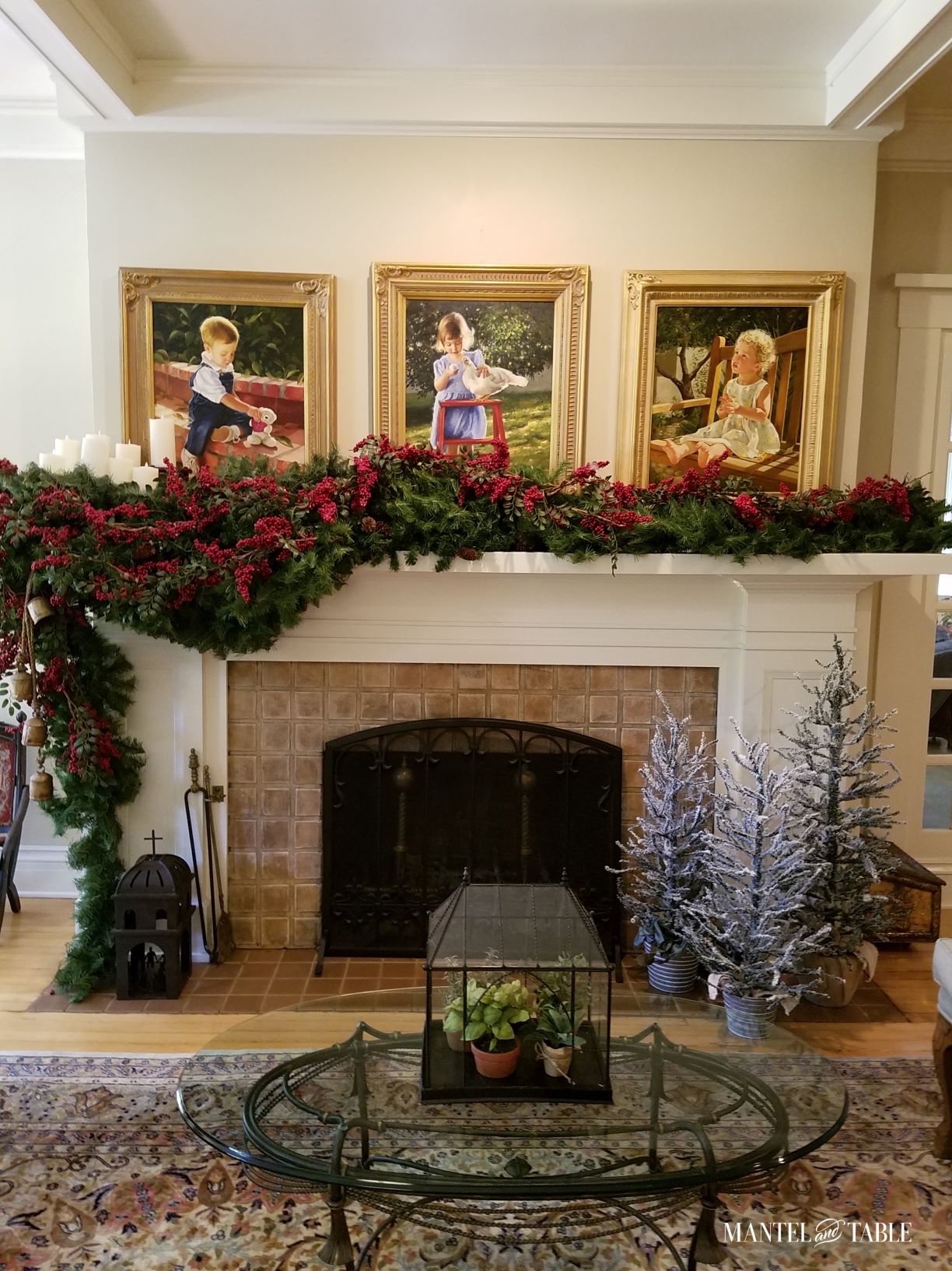 Evergreen garland with red berries on lovely mantel