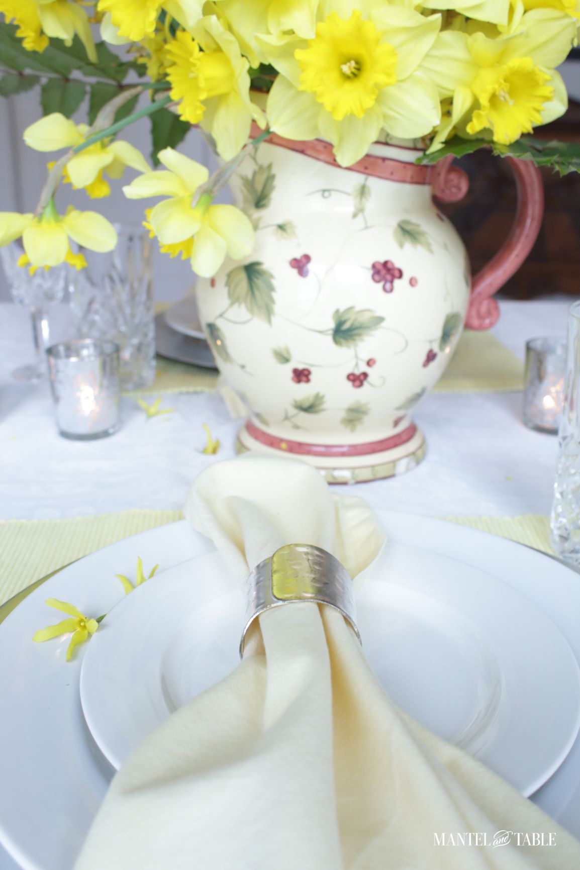 Close up of napkin on the plate stack looking toward the daffodil pitcher centerpiece