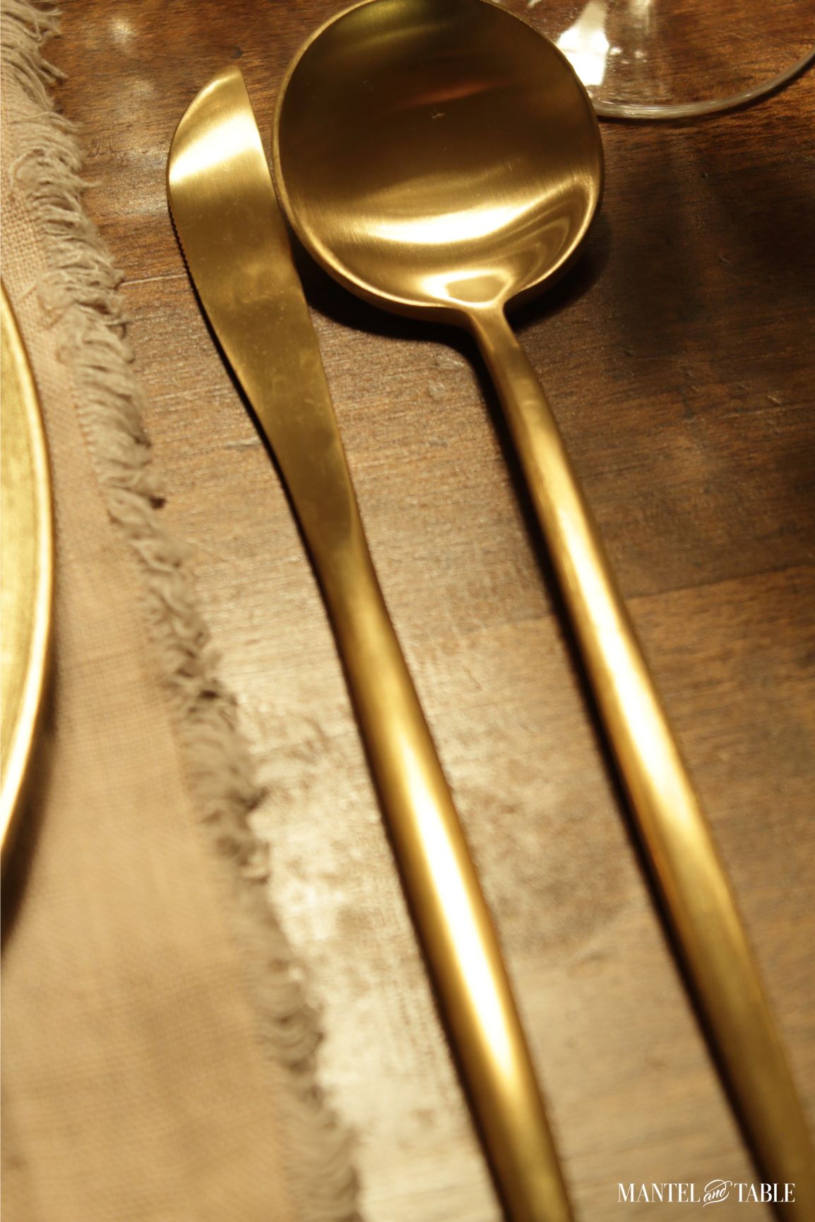 Super-closeup of modern shaped gold knife and spoon