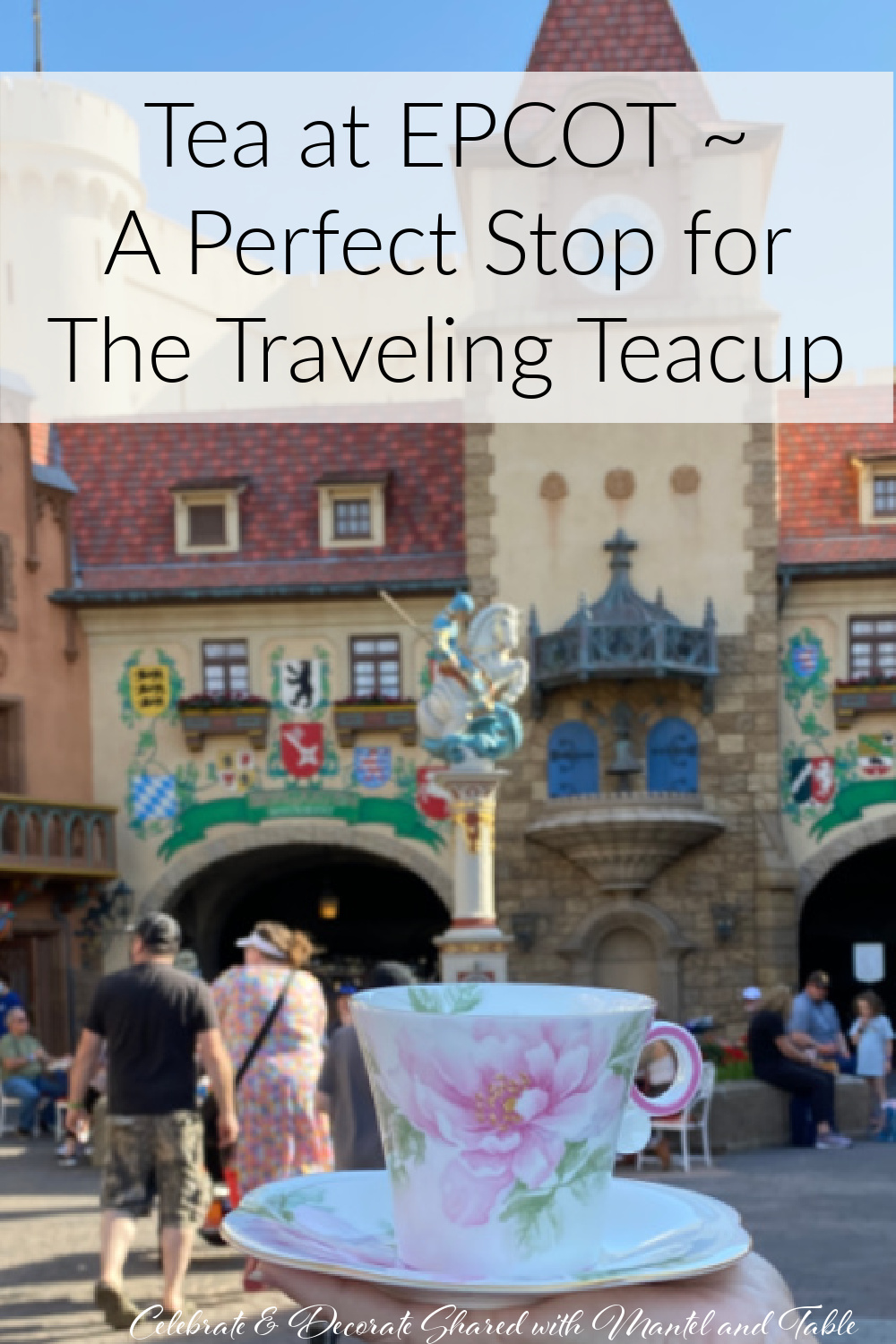 Pink and white teacup held up in front of the Germany Pavilion at EPCOT