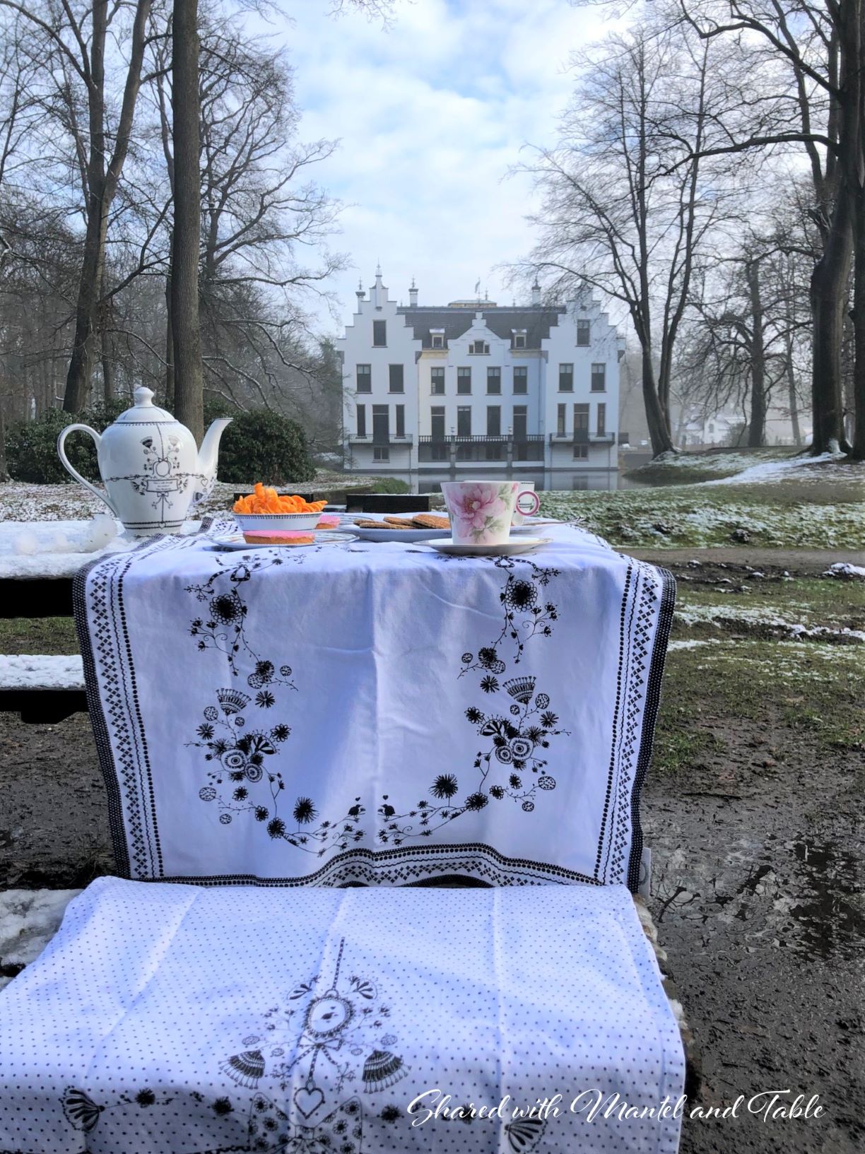 Tea in the Netherlands - Castle in the background, black and white linens on table in foreground