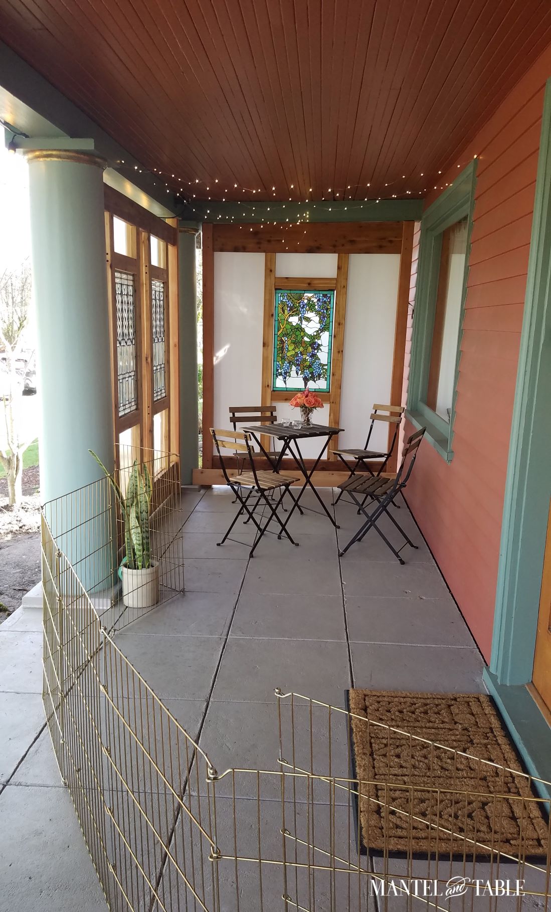 Partially enclosed porch with bistro table and chairs