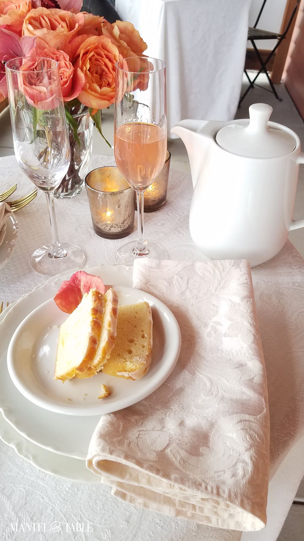 Tablescape with teapot and lemon cake, peach flowers and beverage