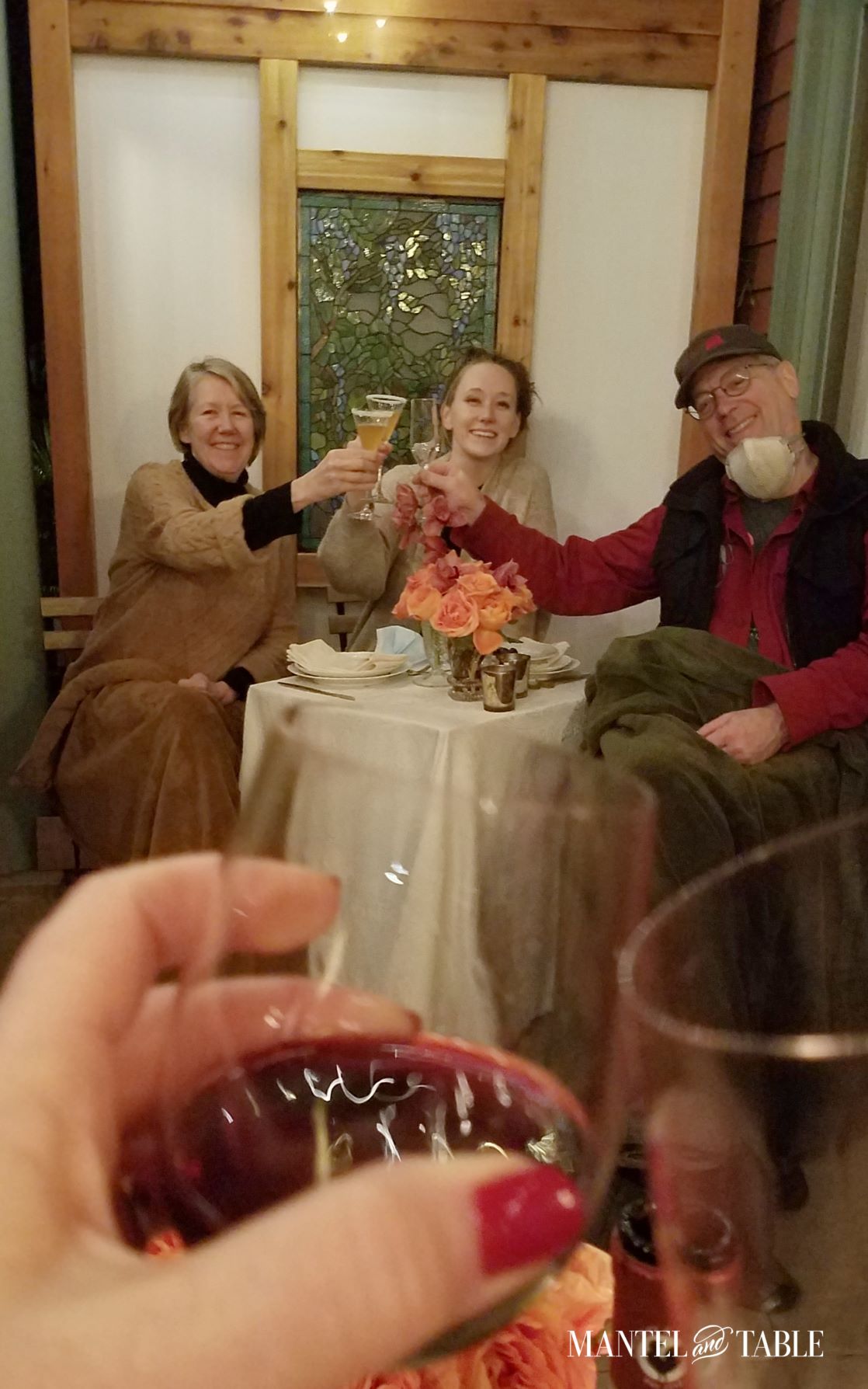 Couple and daughter toasting another couple at Socially distant tables