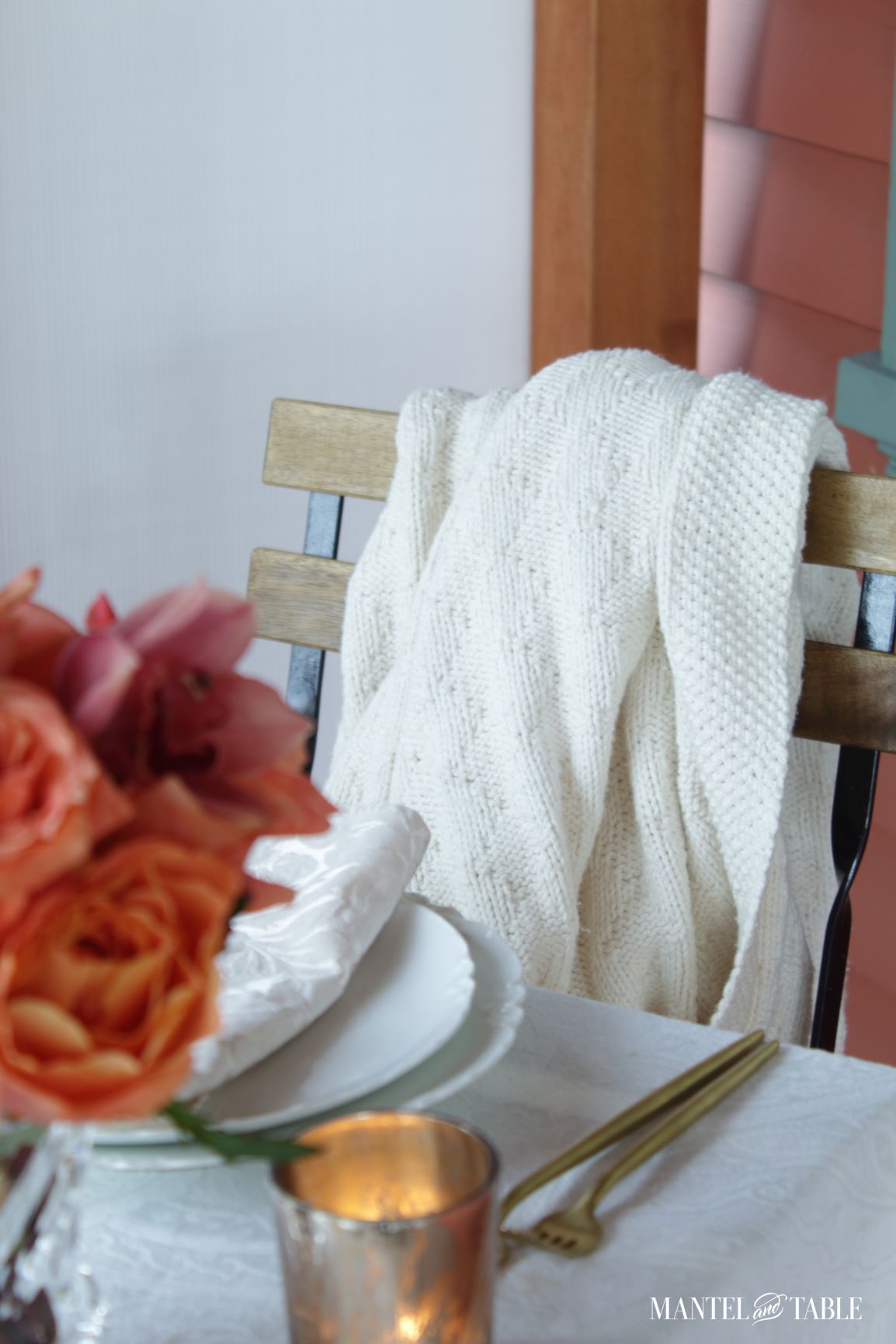 Closeup of white textured blanket draped over a bistro chair