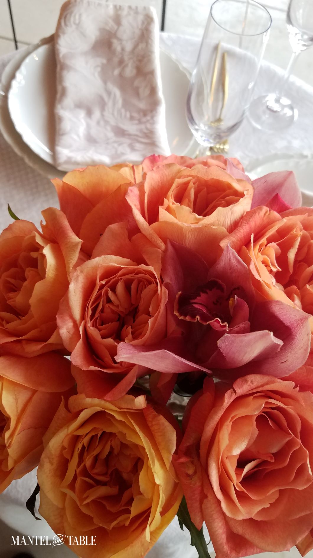 Top view of rose & orchid centerpiece and table setting