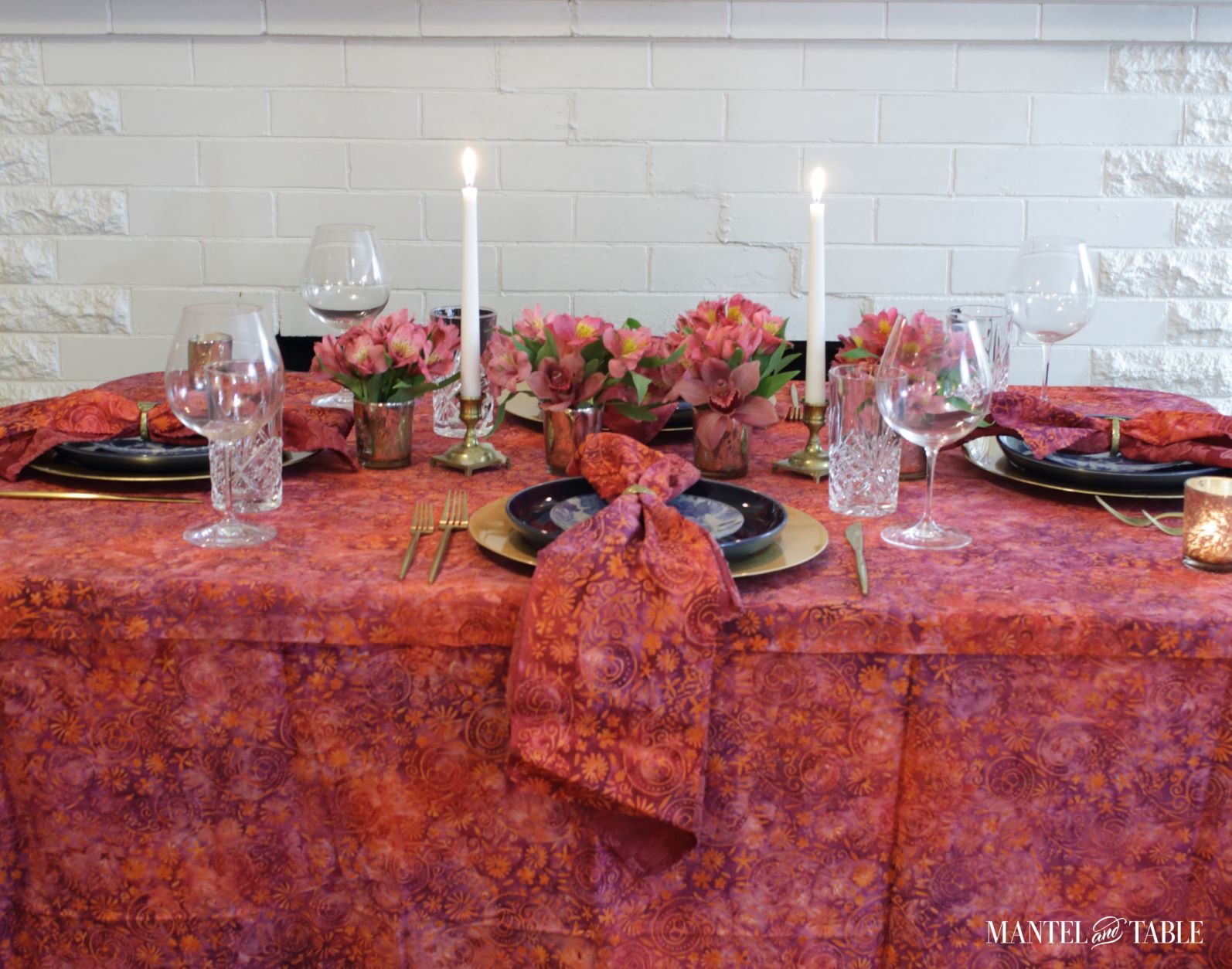 Bright Tablescape - red, purple, & tangerine batik tablecloth, blue and gold place settings