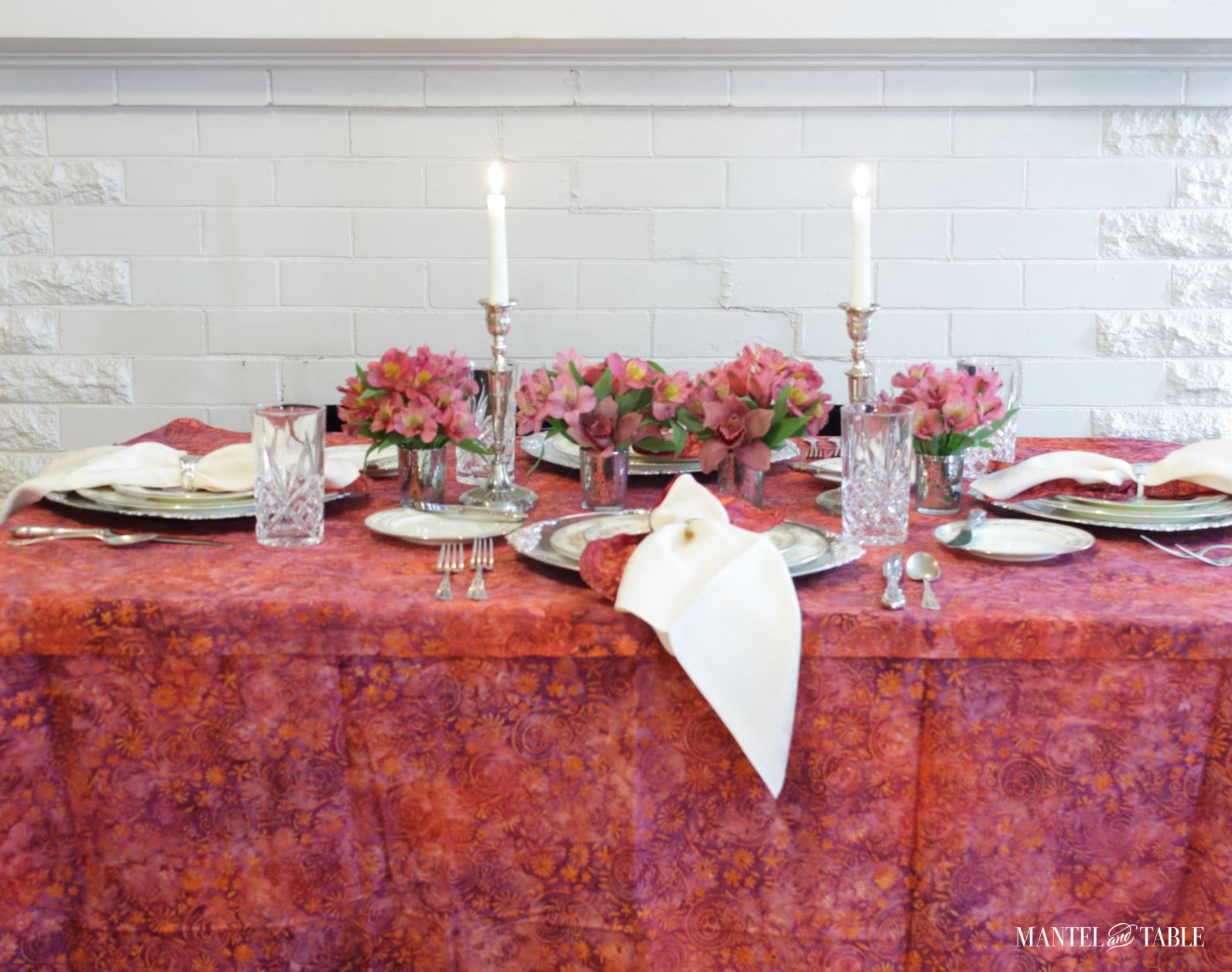 Bright Tablescape - red, purple, & tangerine batik tablecloth, pink and silver place settings