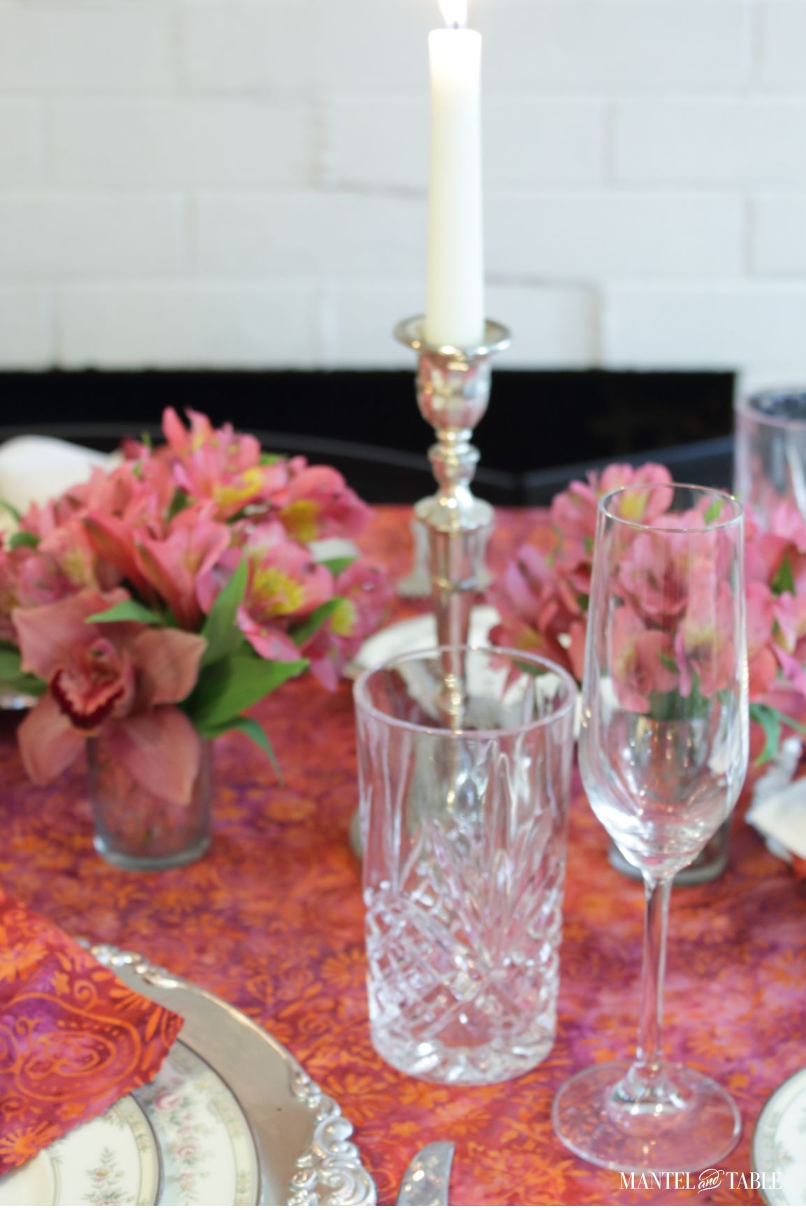 Closeup of water and wine glasses in pink and silver place setting