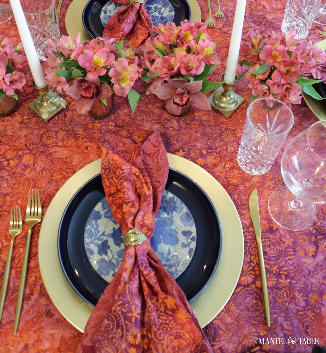 Bright tablescape - red, blue, and gold placesetting from above