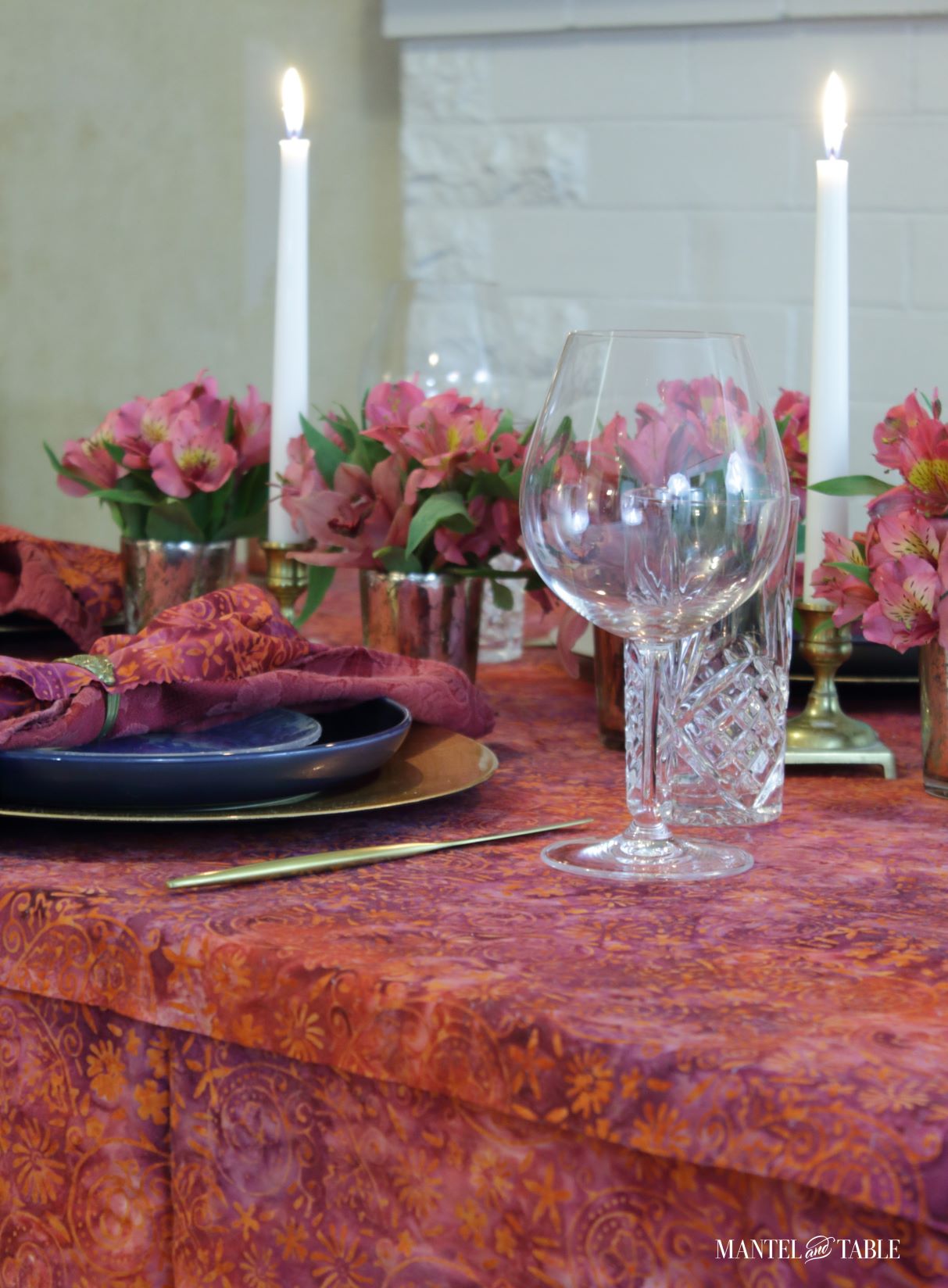 Bright tablescape - diagonal view across blue and gold place setting