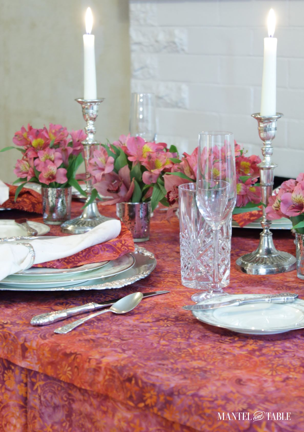 Bright tablescape - diagonal view across pink and silver place setting