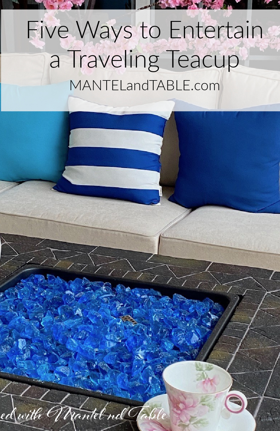Charming Traveling Teacup beside blue firepit and white outdoor couch with blue pillows, pink blossoms, Pinterest banner