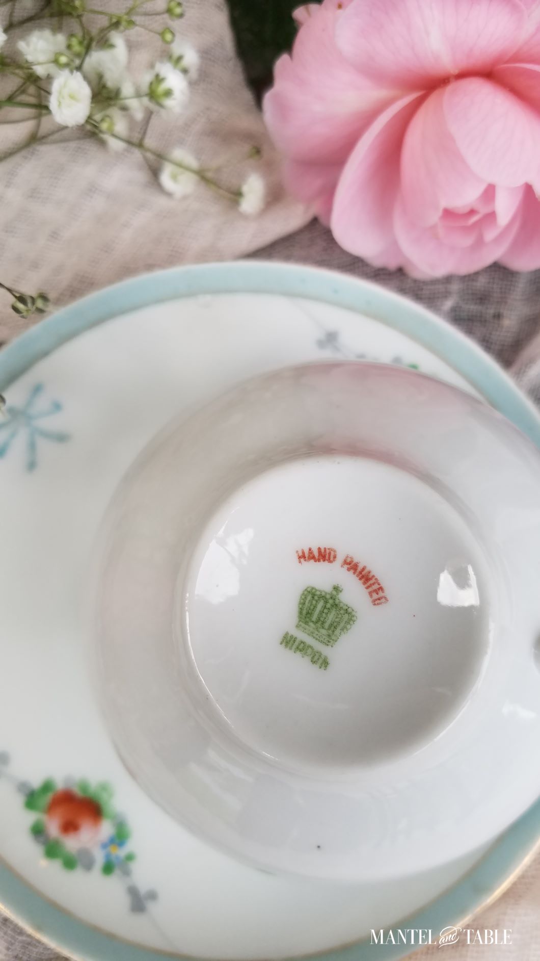 Underside of teacup, backstamp "Hand Painted" above a green crown, "NIPPON" printed below