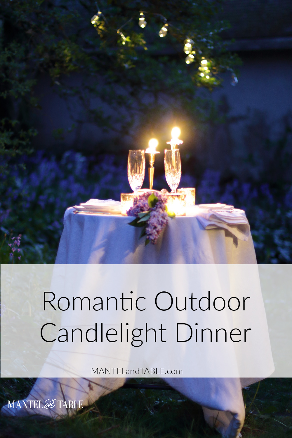 White tabecloth and candlelight on tiny romantic table outdoors