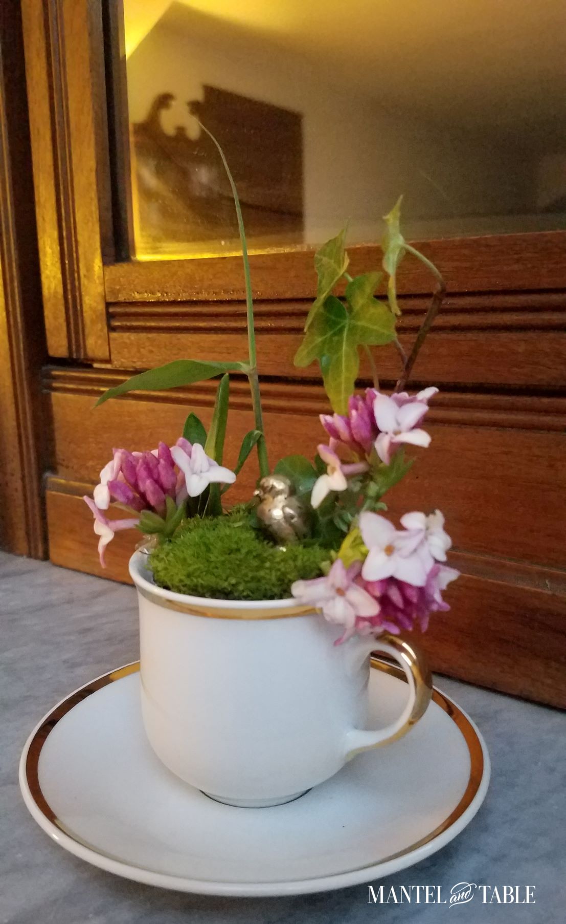 Teacup on bedroom dresser in lamplight