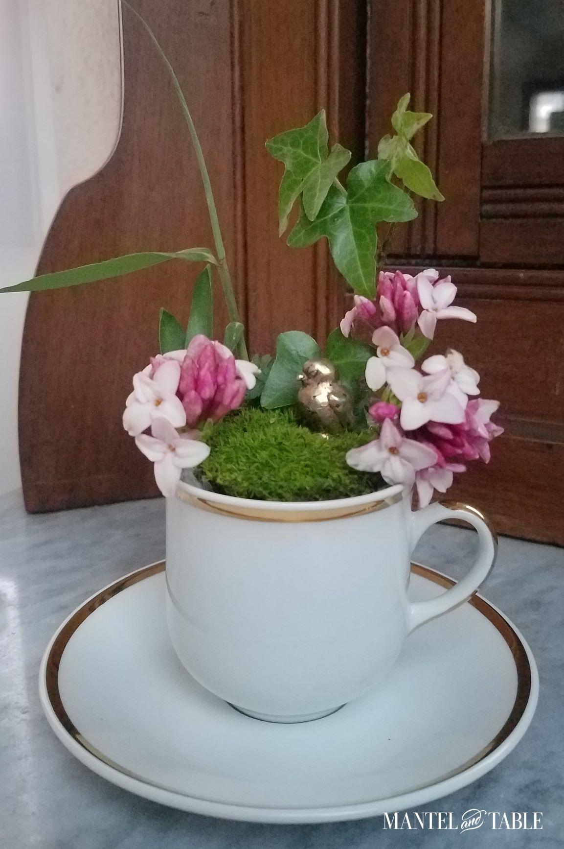 Brass bird in green plants