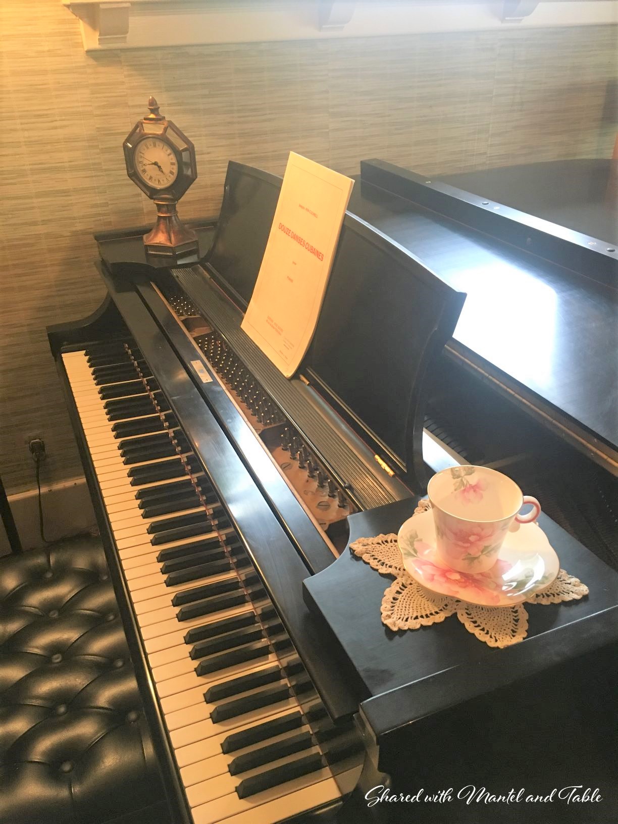 teacup on black grand piano