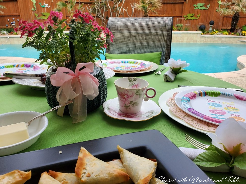 The Traveling Teacup in an Easter tablescape on the patio in front of a pool
