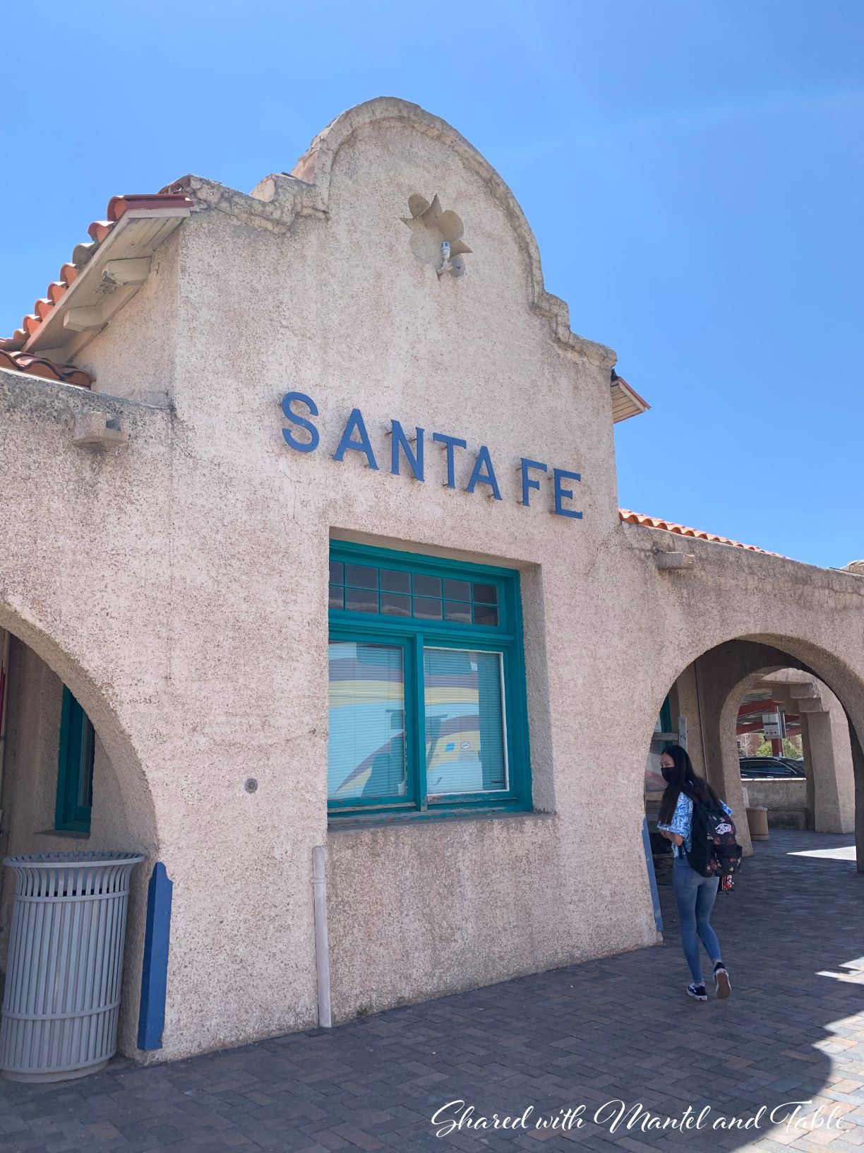 Lovely old stucco and tile roofed building with "SANTA FE" sign on front