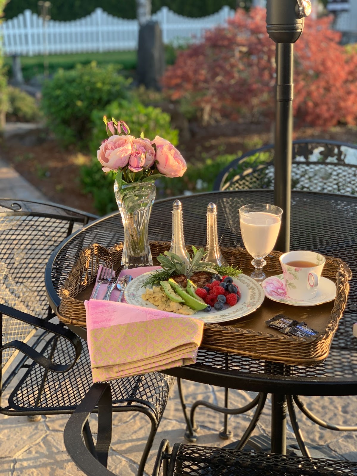 The Traveling Teacup on an elegant breakfast tray, morning sun in the garden