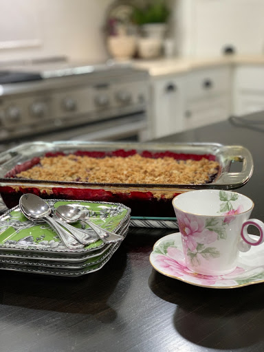 Teacup, dessert plates & spoons, blackberry cobbler on kitchen counter
