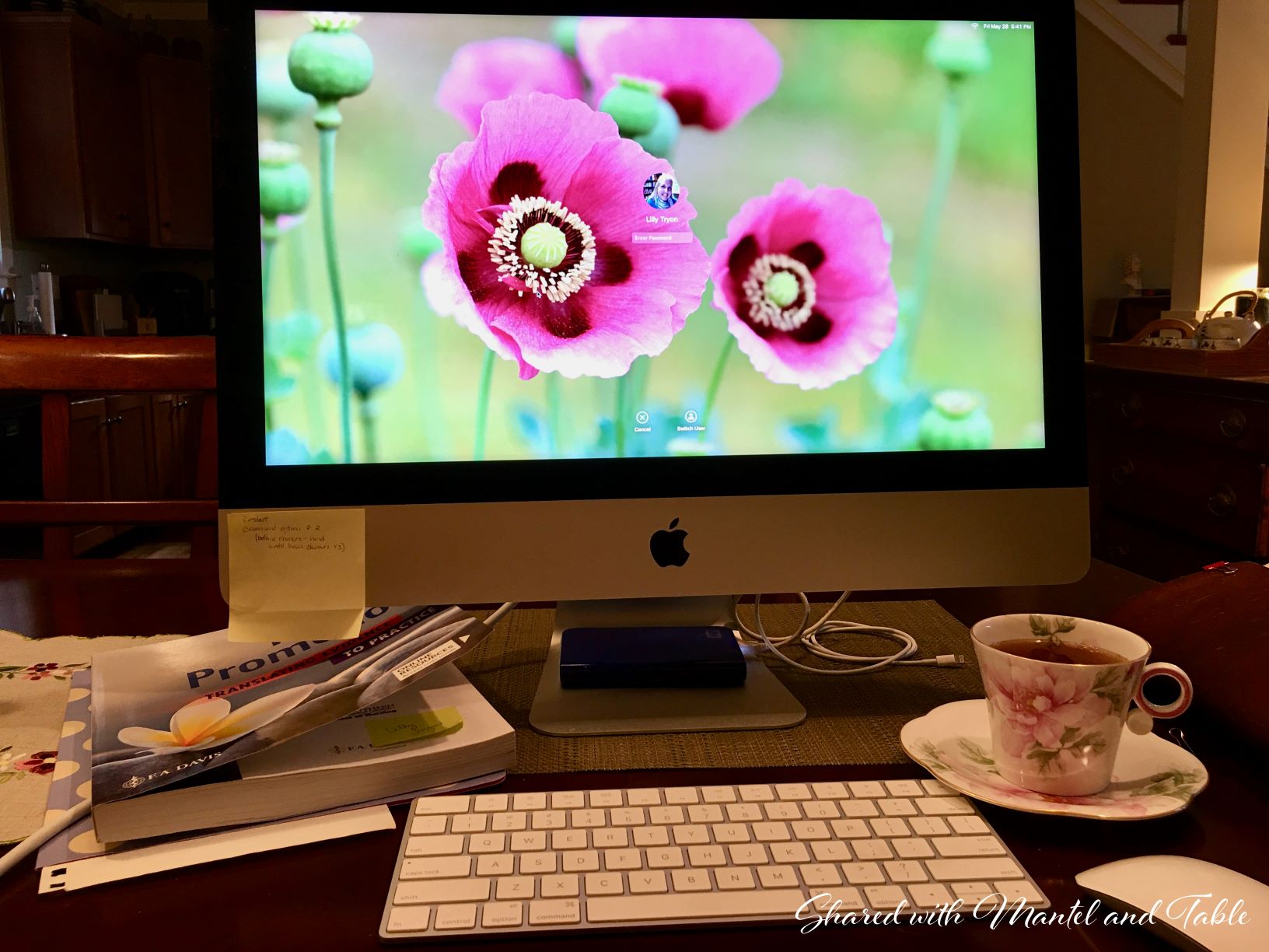 Teacup next to computer screen on a table