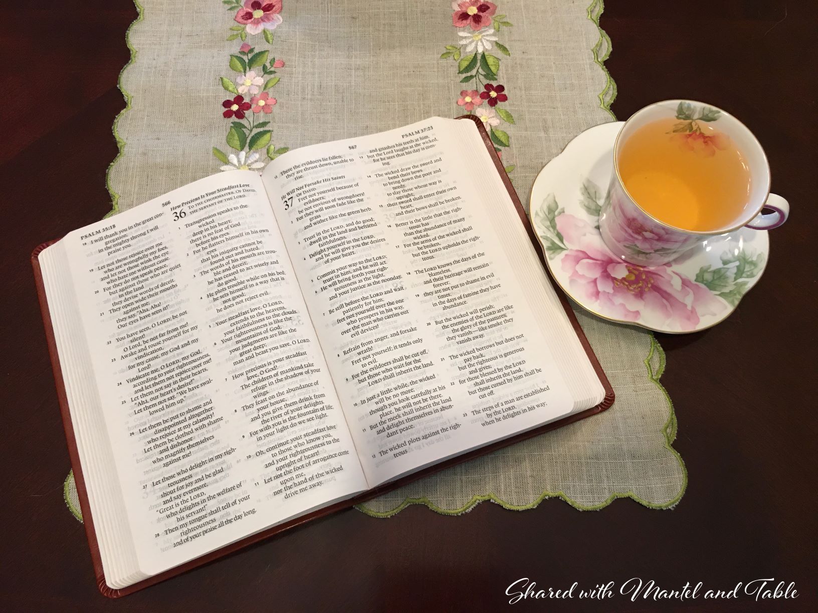 Teacup on table with open bible