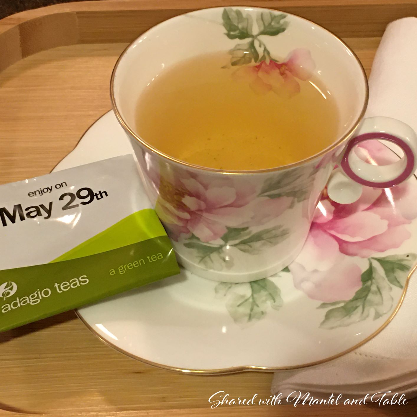 Teacup with tea and Adagio tea packet