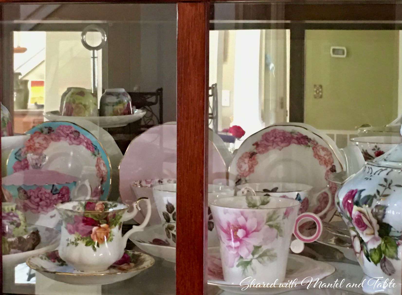 Teacups behind china cabinet doors