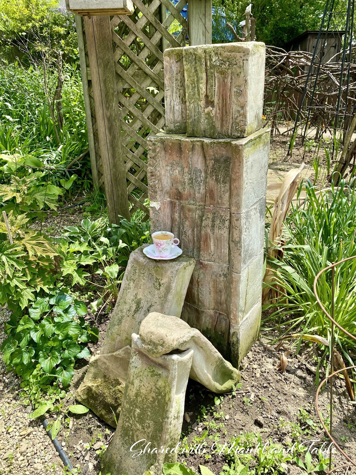 The Traveling Teacup on modern sculpture in garden