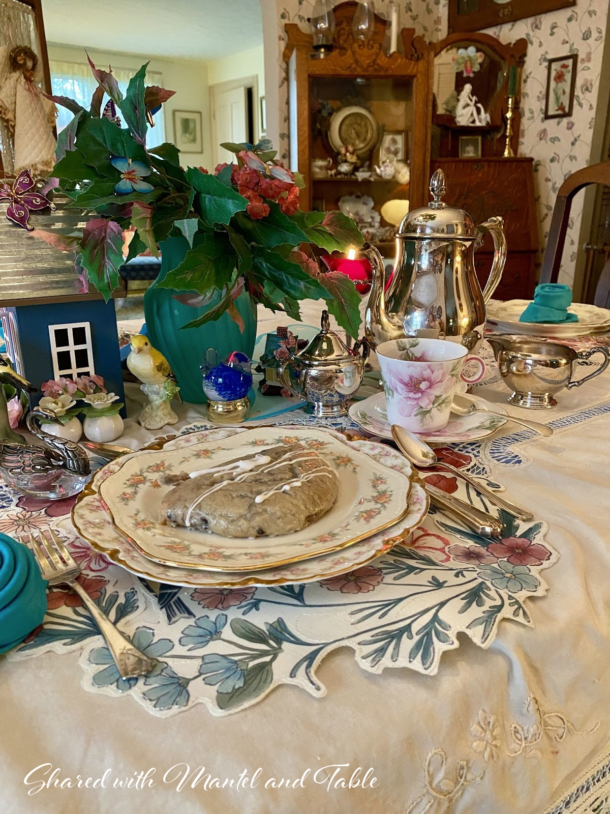 Breakfast table set with silver tea service and pastry