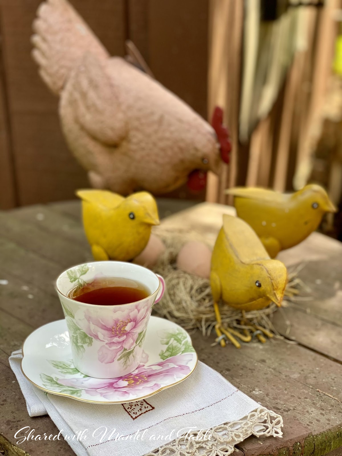 Teacup with sculpture of chicken, chicks, and nes with eggs