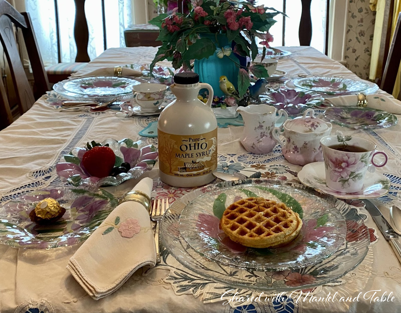 Closeup of waffles and maple syrup bottle