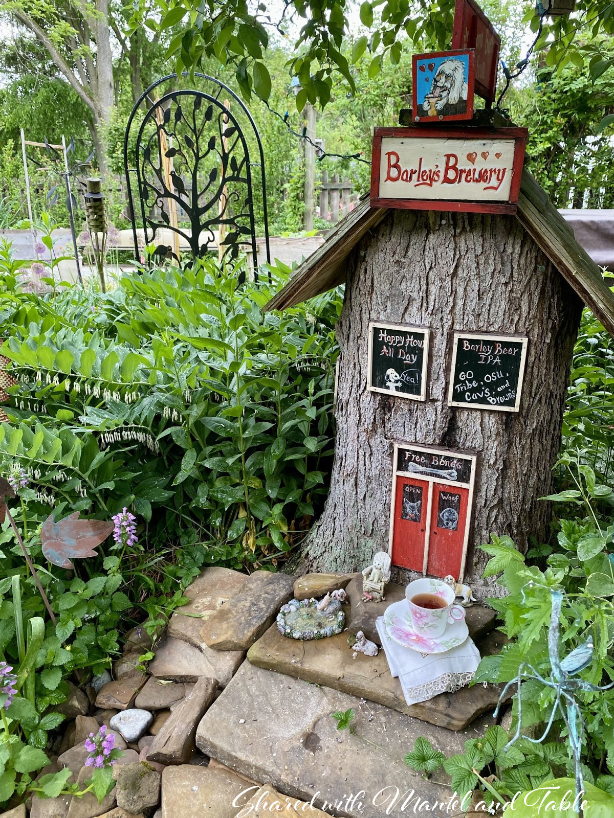 Teacup with tree stump decorated to look like rustic brewery building