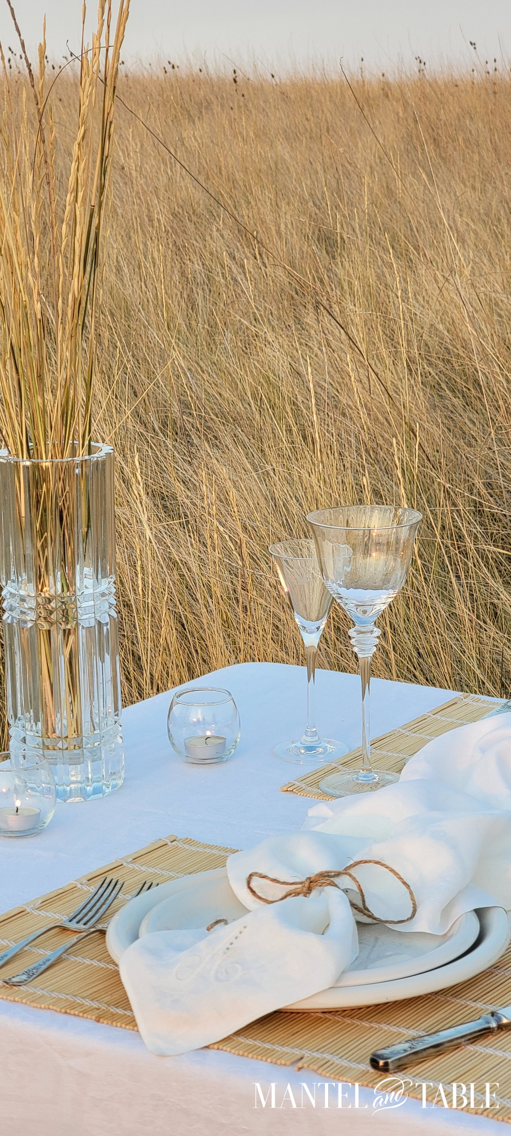 Closeup of glass vase, candles, and glassware