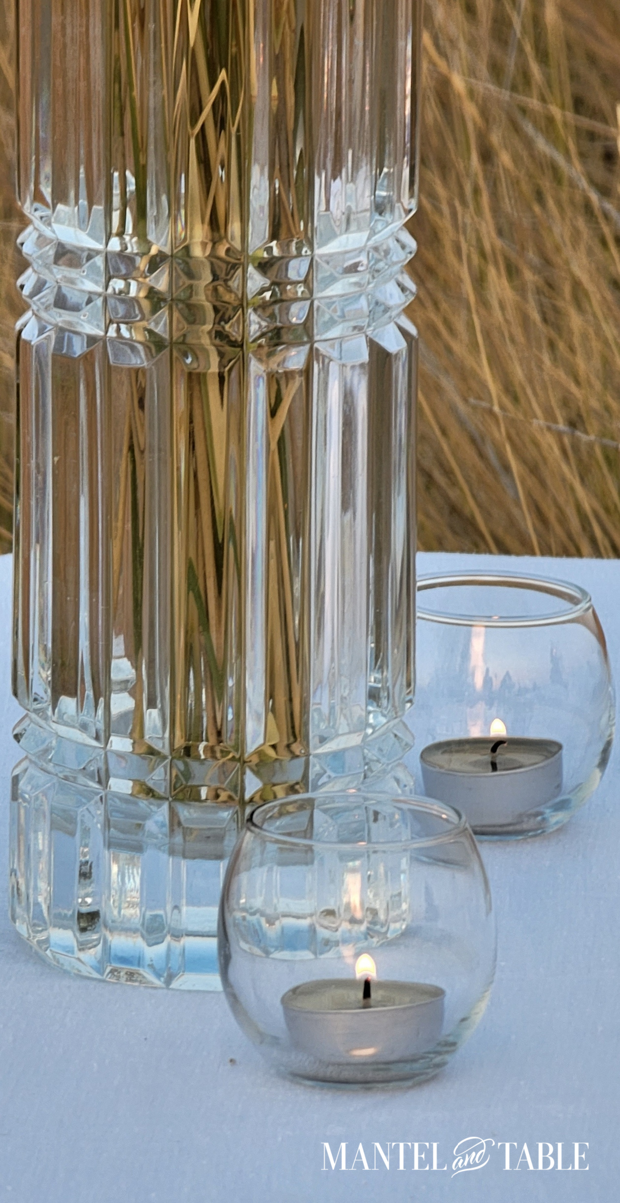 Super closeup of cut glass vase and clear tea candle holders