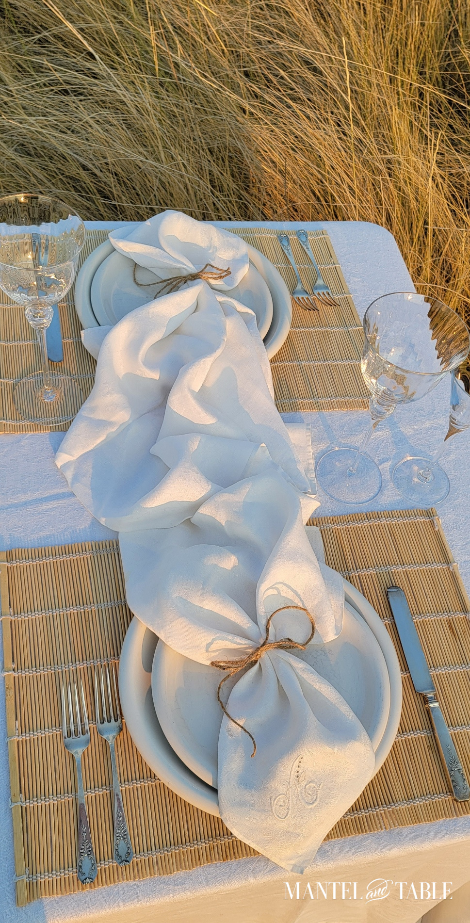 Top view of white linen monogrammed napkins at place setting