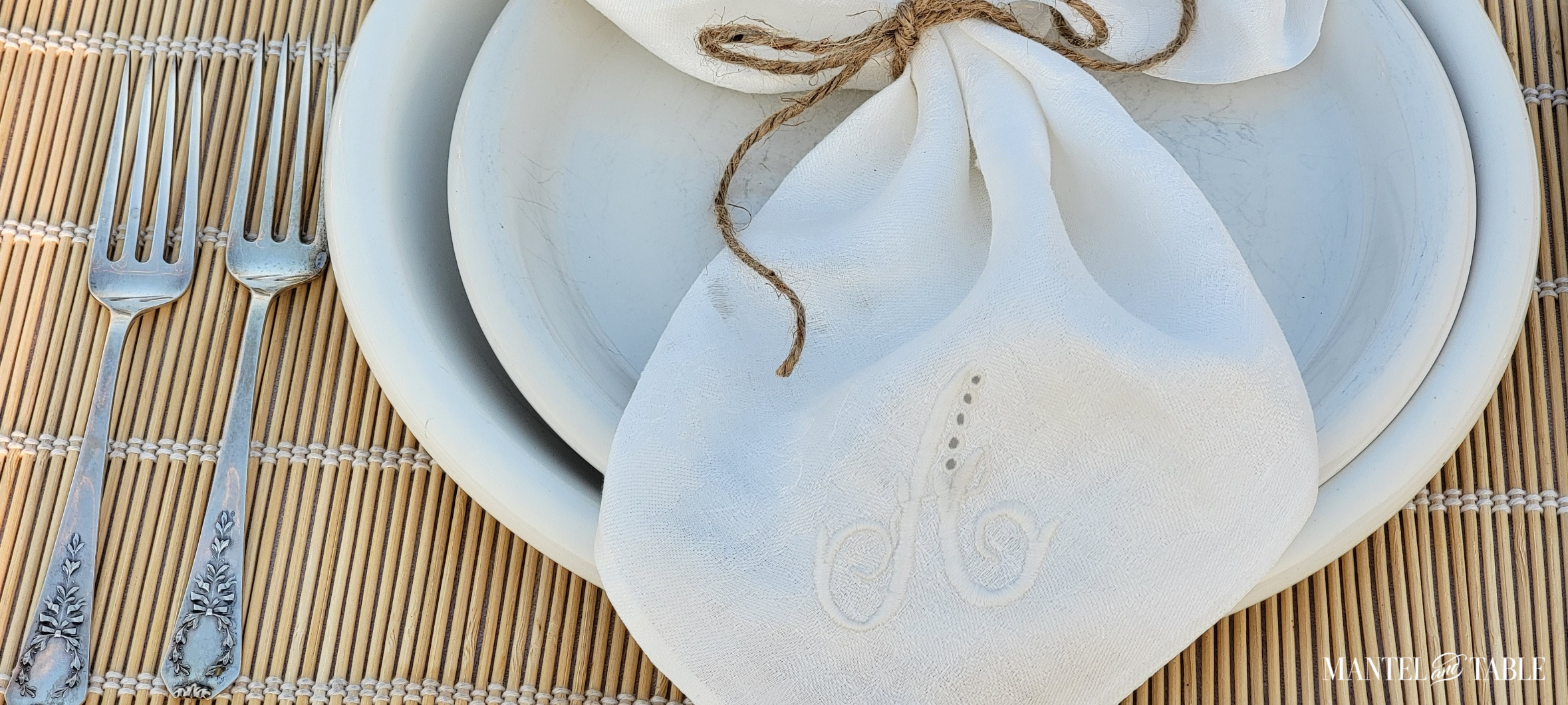 Closeup of monogrammed linen napkin secured with kitchen twine