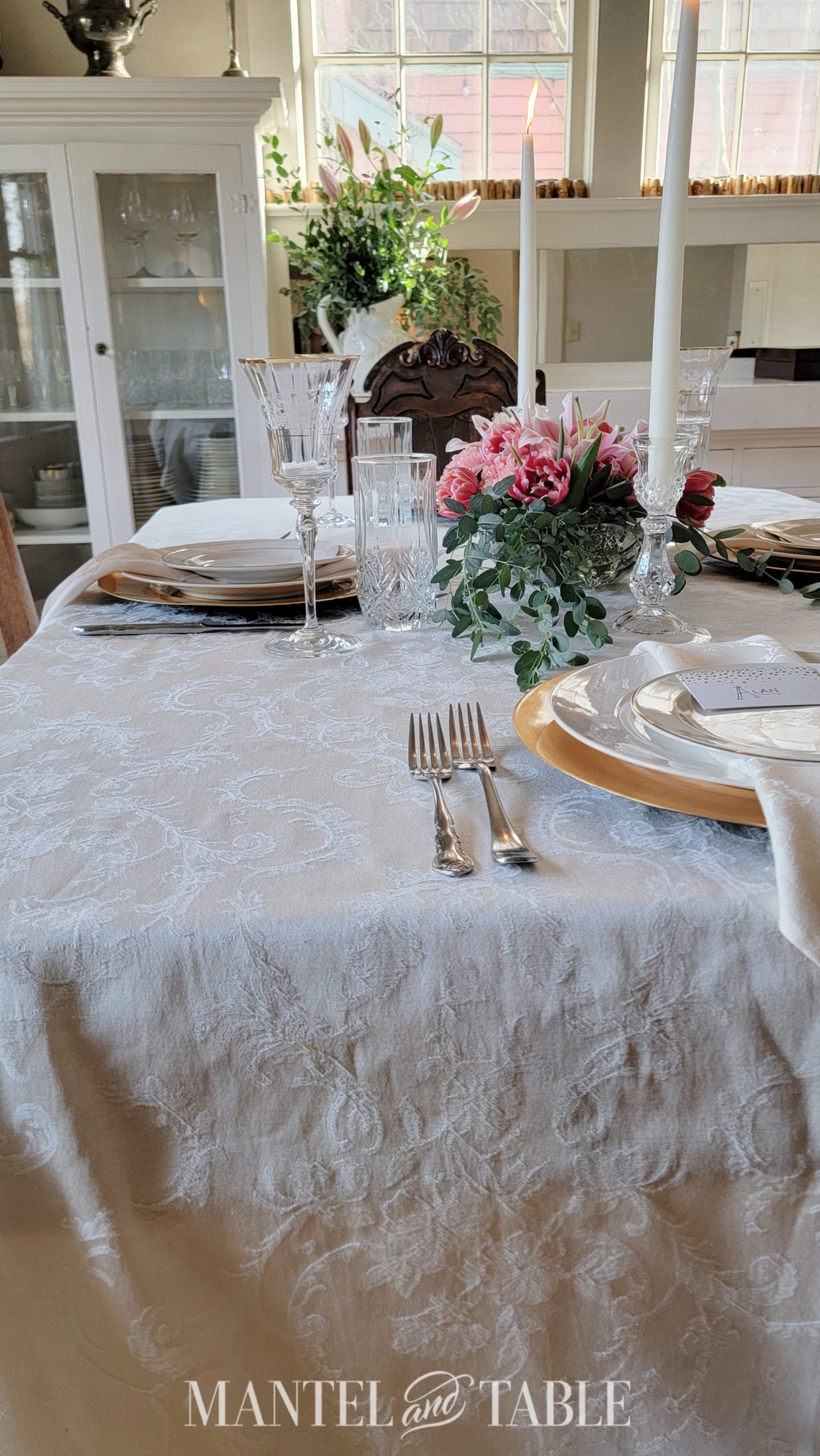 Side view of table set with gold, silver, and white
