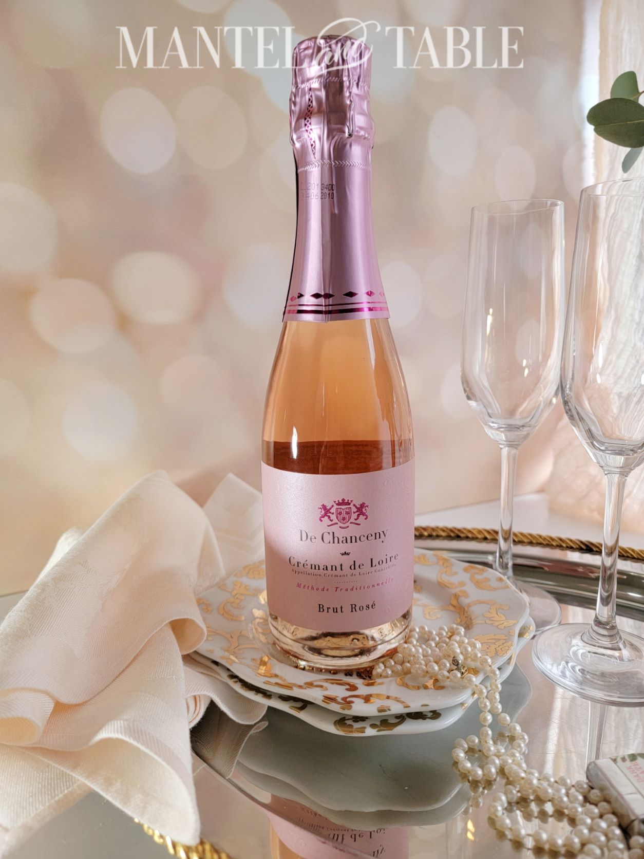 Bottle of pink champagne with pearls