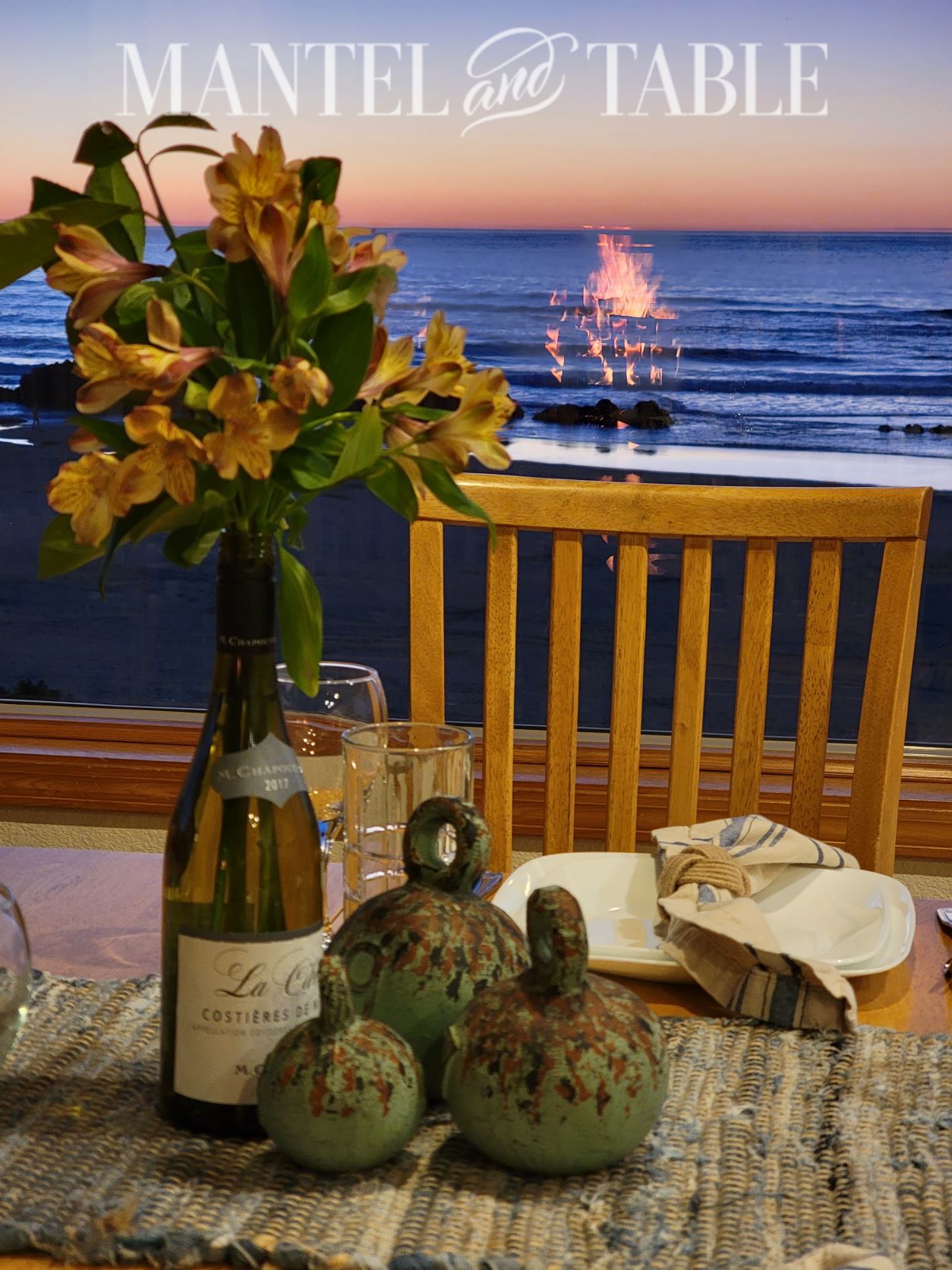Set a Beautiful Table - closeup of centerpiece with fireplace flames reflected in window with sunset