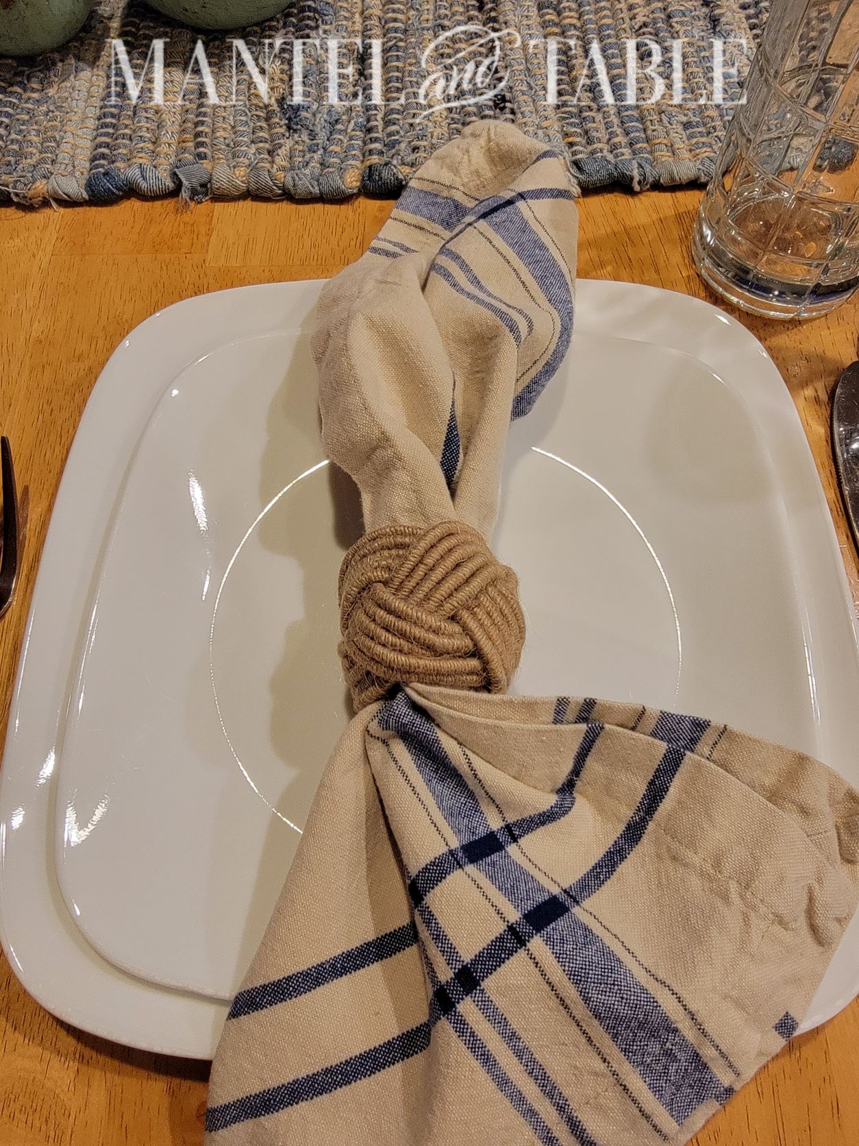 Set a beautiful table - closeup of khaki and blue plaid napkin and rope napkin ring