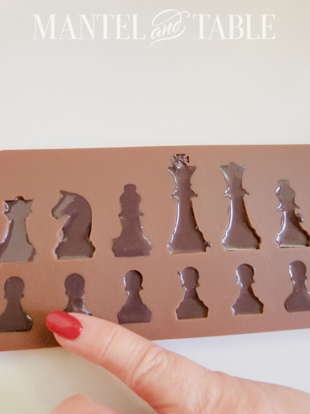 Wiping melted chocolate from molds